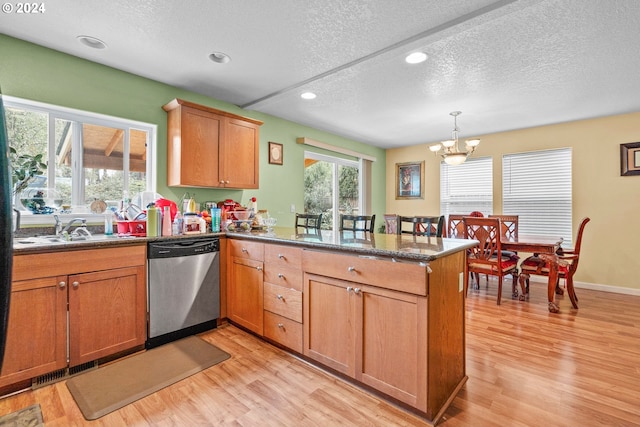 kitchen featuring dishwasher, light wood-type flooring, and kitchen peninsula