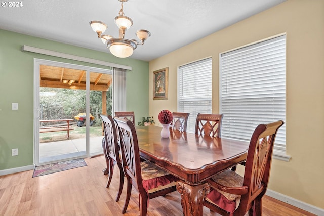 dining room featuring an inviting chandelier and light hardwood / wood-style floors