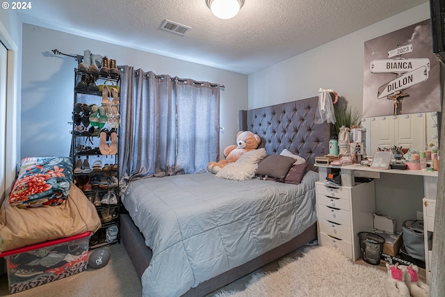 carpeted bedroom with a textured ceiling