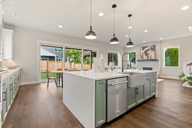 kitchen with dishwasher, a healthy amount of sunlight, decorative light fixtures, and a center island with sink