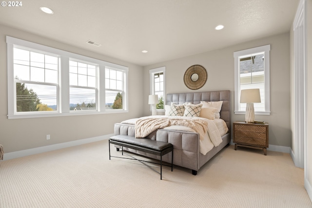 bedroom featuring recessed lighting, visible vents, light carpet, and baseboards