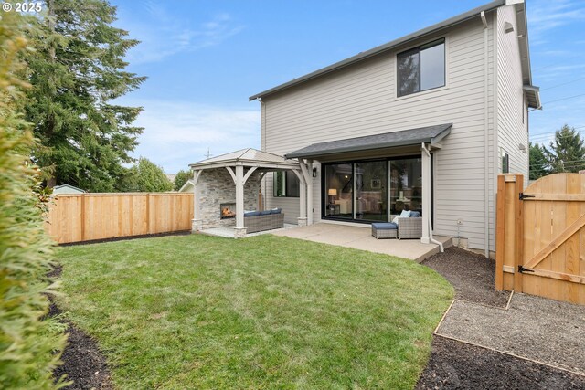 view of patio / terrace with a gazebo and an outdoor stone fireplace