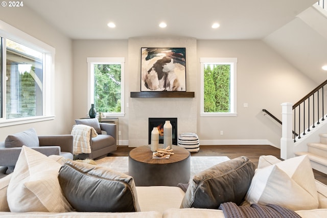 living room with a fireplace, stairway, wood finished floors, and recessed lighting