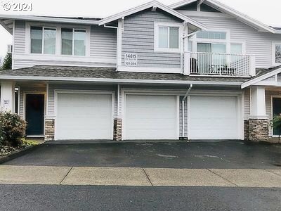 exterior space with a garage and a balcony