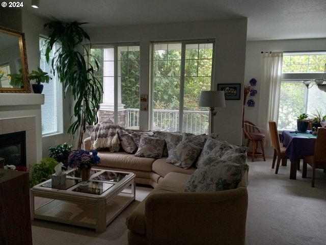 carpeted living room with plenty of natural light and a tile fireplace