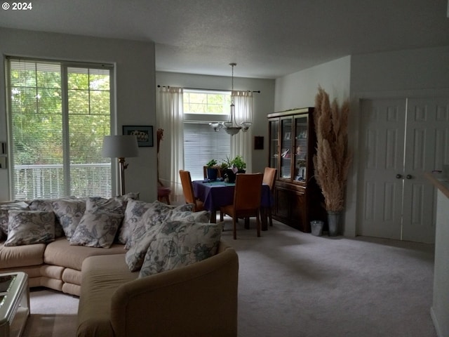 living room featuring carpet flooring and a notable chandelier