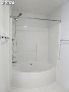 bathroom featuring tile floors and bathing tub / shower combination