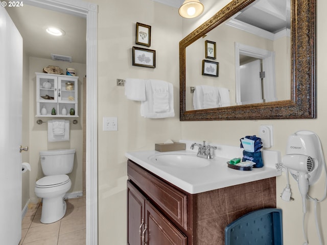 bathroom featuring vanity, crown molding, toilet, and tile patterned floors