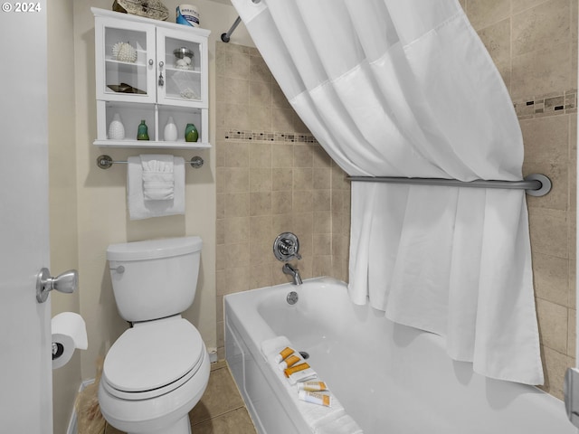 bathroom with shower / bath combo with shower curtain, toilet, and tile patterned flooring