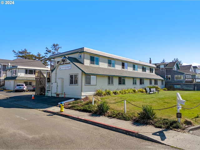 view of front of property with a garage and a front lawn