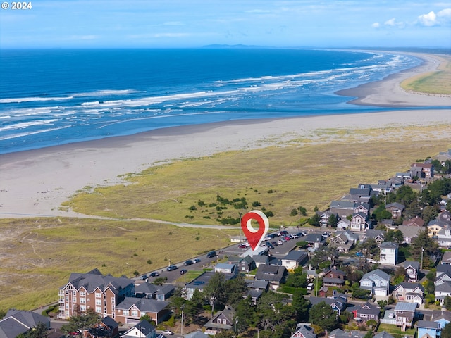 birds eye view of property with a view of the beach and a water view