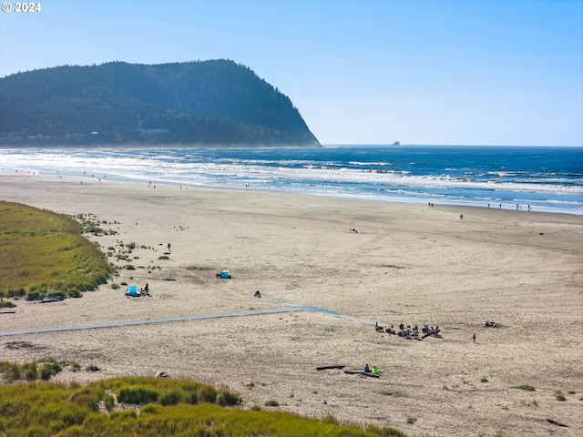 water view with a beach view and a mountain view