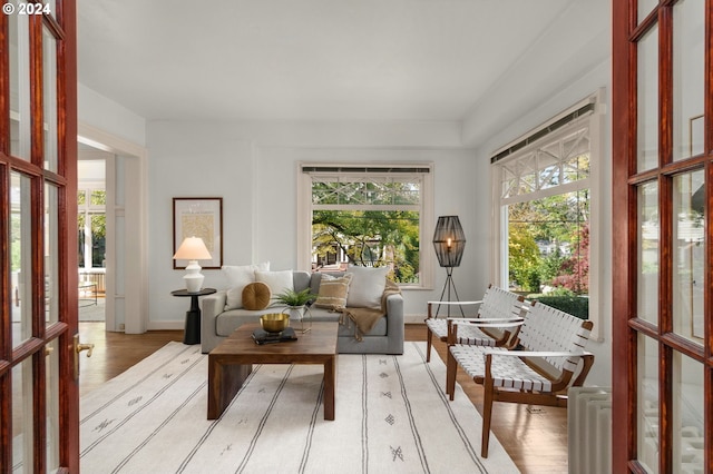 sunroom / solarium with french doors, radiator heating unit, and plenty of natural light