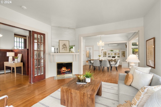 living room with hardwood / wood-style floors and a chandelier