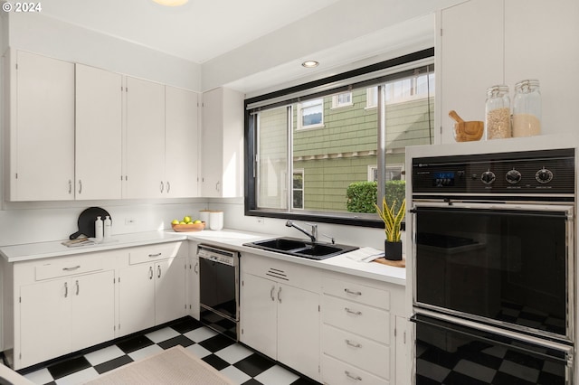 kitchen featuring sink, black appliances, and white cabinetry