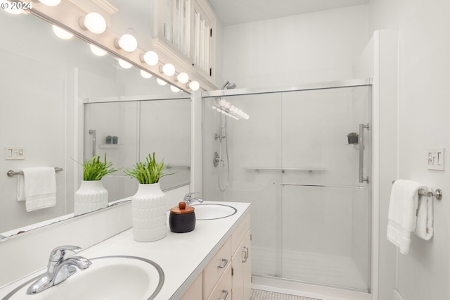 bathroom with vanity and a shower with shower door