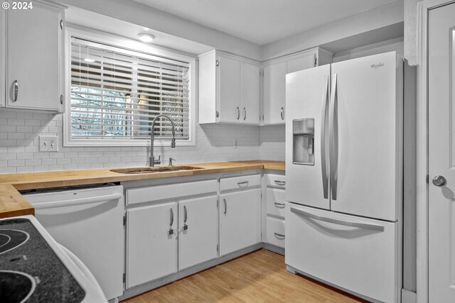 kitchen with white cabinets, white appliances, backsplash, and sink