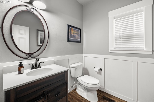 bathroom featuring vanity, hardwood / wood-style flooring, and toilet