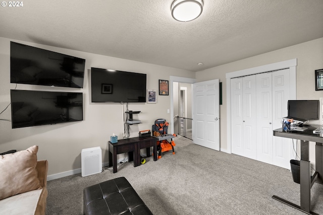 interior space featuring carpet floors and a textured ceiling