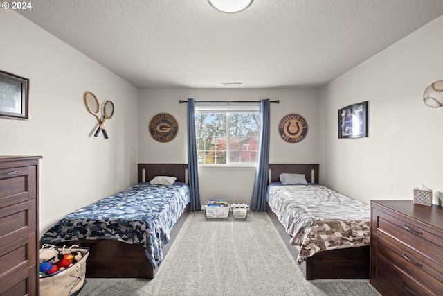 bedroom with carpet flooring and a textured ceiling