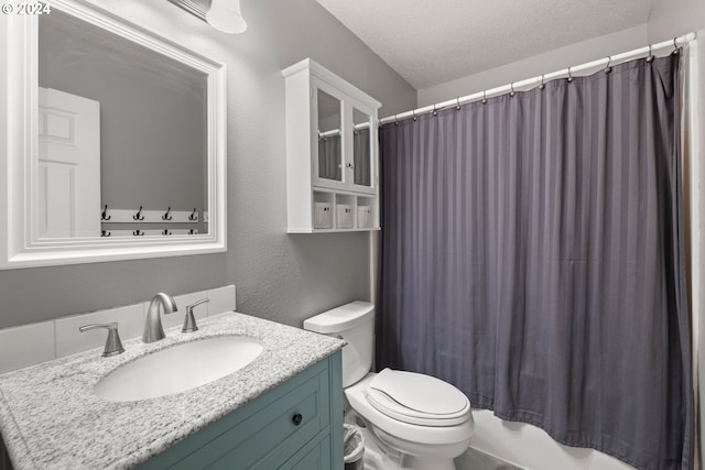 full bathroom with vanity, shower / tub combo, a textured ceiling, and toilet