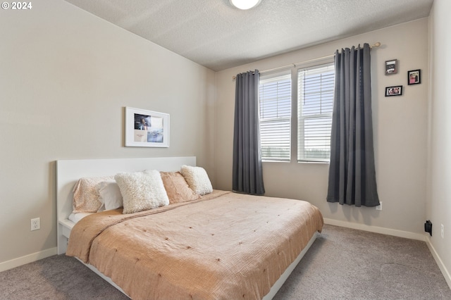 carpeted bedroom with a textured ceiling