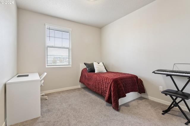 carpeted bedroom featuring a textured ceiling