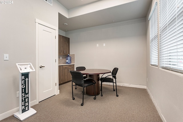 dining space featuring light colored carpet