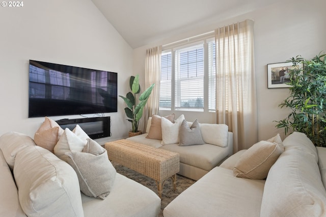 living room featuring high vaulted ceiling