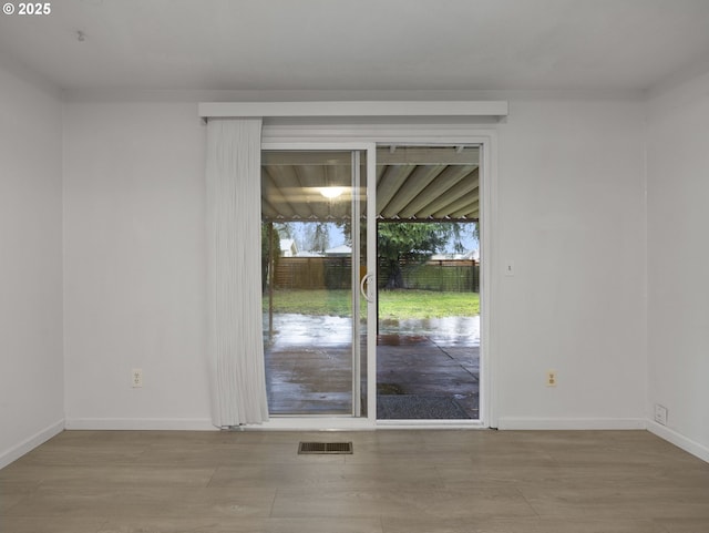 unfurnished room with light wood-type flooring