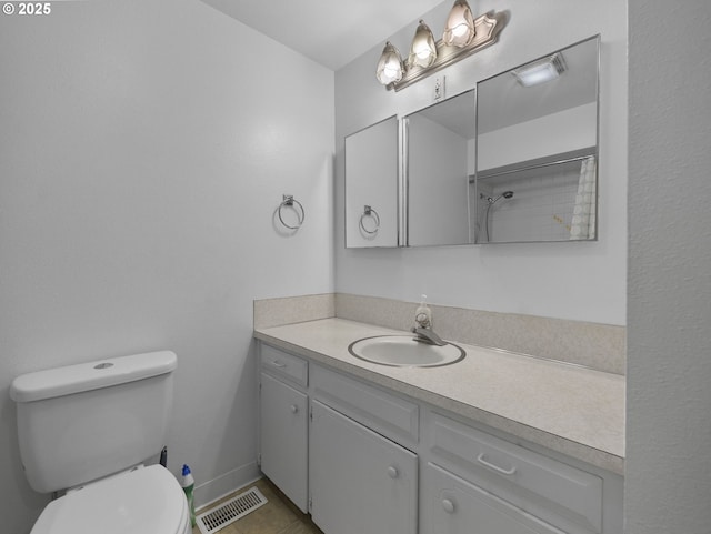 bathroom featuring tile patterned flooring, vanity, and toilet