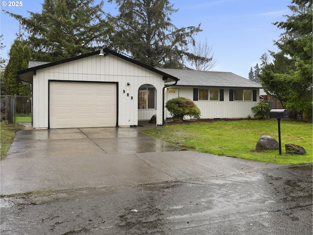 ranch-style house featuring a garage and a front lawn