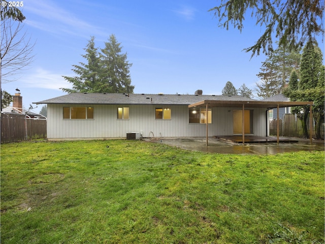 back of house with a patio area and a yard