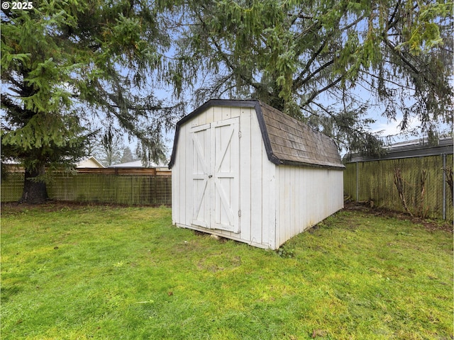 view of outdoor structure featuring a lawn