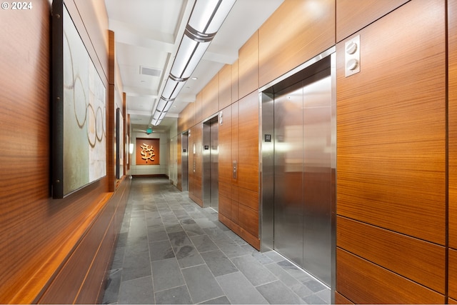 hallway with elevator and visible vents