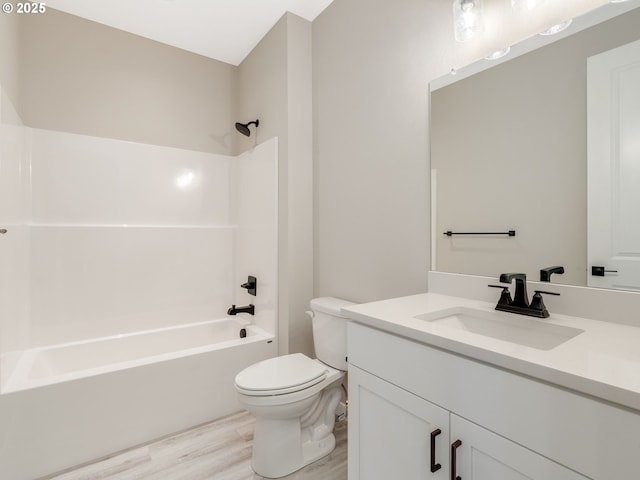 full bathroom with hardwood / wood-style flooring, vanity,  shower combination, and toilet