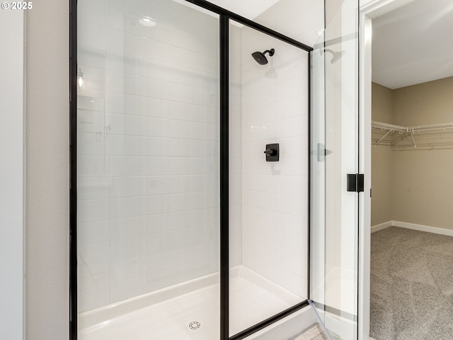 bathroom featuring a shower with door