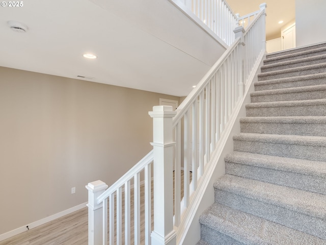 stairway featuring hardwood / wood-style floors