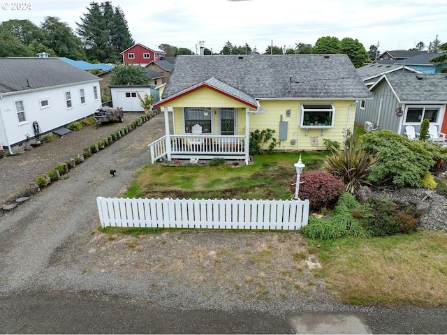 view of front of property with a storage shed and covered porch