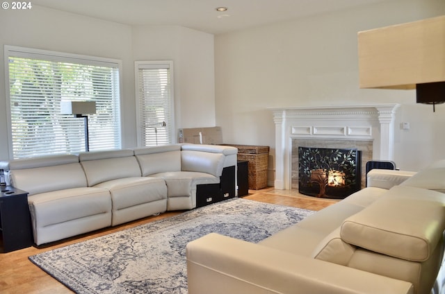 living room with a fireplace and light wood-type flooring