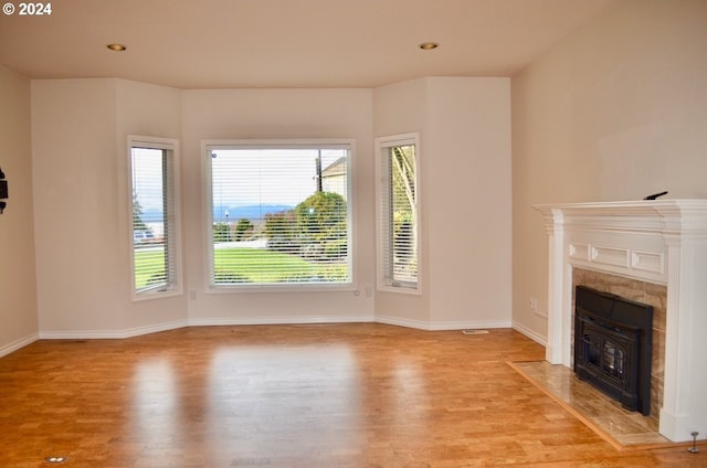 unfurnished living room featuring a wealth of natural light and light hardwood / wood-style flooring