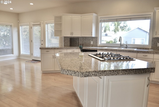 1519 NW 79th Cir, Vancouver, WA 98665 - kitchen with stainless steel gas stovetop, a kitchen island, tasteful backsplash, light wood finished floors, and recessed lighting