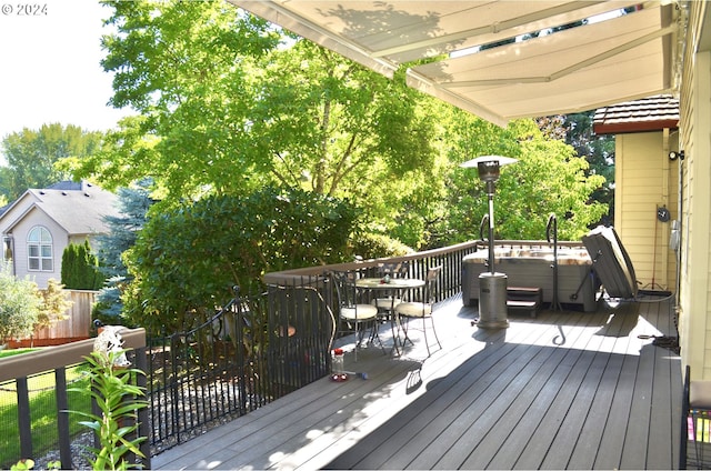 wooden terrace with a hot tub