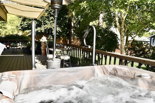 wooden deck featuring a hot tub