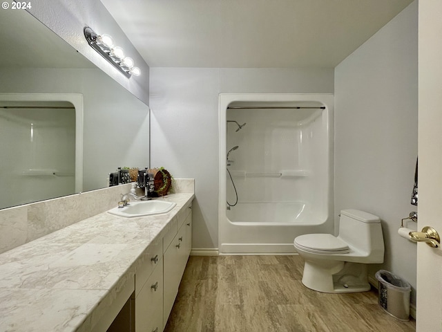 full bathroom featuring hardwood / wood-style flooring, vanity, toilet, and bathtub / shower combination