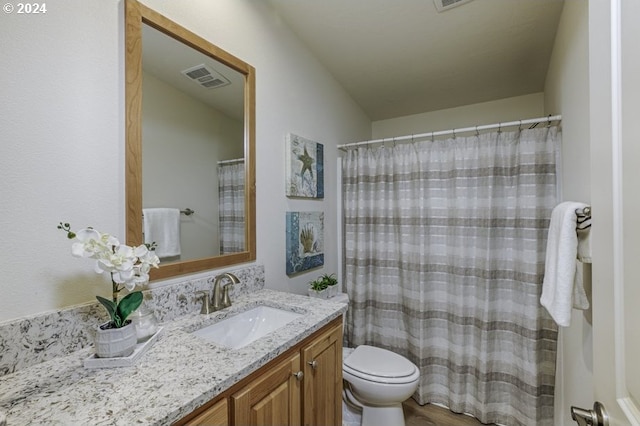 bedroom featuring carpet, a walk in closet, a closet, ensuite bath, and vaulted ceiling