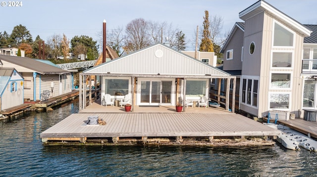 rear view of property with a water view