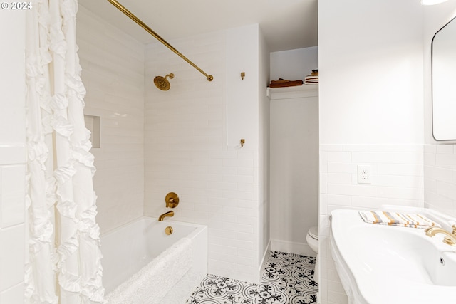 full bathroom with sink, tile patterned floors, toilet, shower / tub combo with curtain, and tile walls