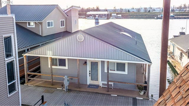 back of property with a water view