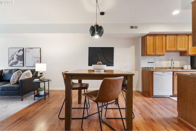 kitchen with sink, light wood-type flooring, and dishwasher